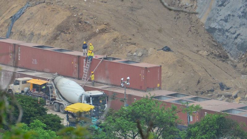 El Ministerio de Obras Públicas coloca contenedores rellenados con lodocreto en un talud de los chorros mientras intenta estabilizar el talud de tierra.