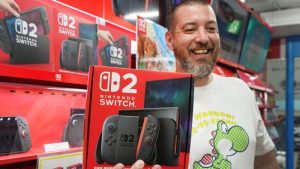 Esta foto de archivo, tomada el 5 de junio de 2025, muestra a un cliente francés residente en Tokio sonriendo mientras muestra una Nintendo Switch 2 comprada en una tienda de electrónica de Tokio.