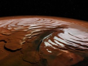 Imagen facilitada por la Agencia Espacial Europea (ESA) del casquete polar norte de Marte, con el cañón conocido como Chasma Boreale, una de las fotografías ofrecidas por este organismo en las que se aprecia distintivas fosas espirales de color oscuro del planeta. / Foto Archivo