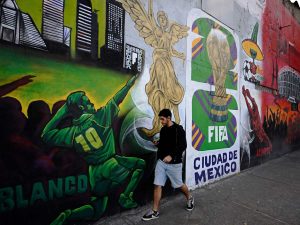 Un hombre pasa junto a un mural relacionado con la Copa Mundial de la FIFA 2026 en la Ciudad de México el 5 de diciembre de 2025.