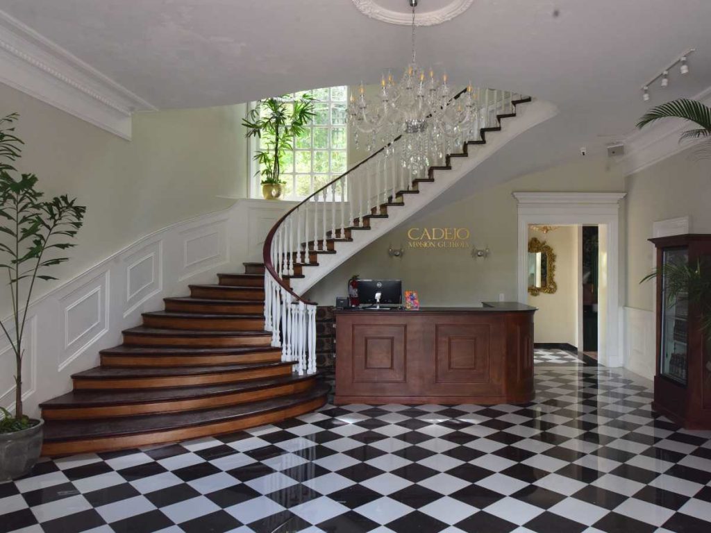 El lobby del nuevo Cadejo en la Mansión Guirola funciona como punto de bienvenida y conserva la esencia clásica del inmueble, ahora integrada con arte y diseño contemporáneo.