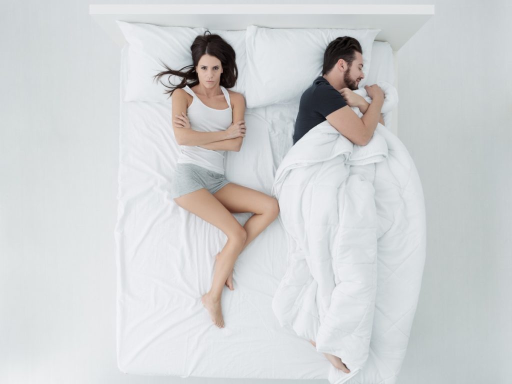 El “ladrón de cobijas” es uno de los conflictos más comunes al dormir en pareja; usar mantas individuales puede evitar tironeos y microdespertares.