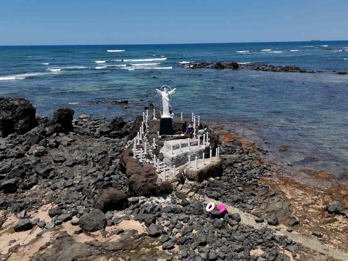 El Cristo de Salinitas se alza entre rocas y mar, uno de los atractivos más emblemáticos de esta playa de acceso controlado en, Acajutla, Sonsonate.