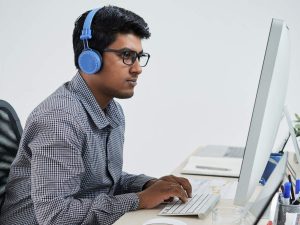 Indian programmer listening to music when working in office