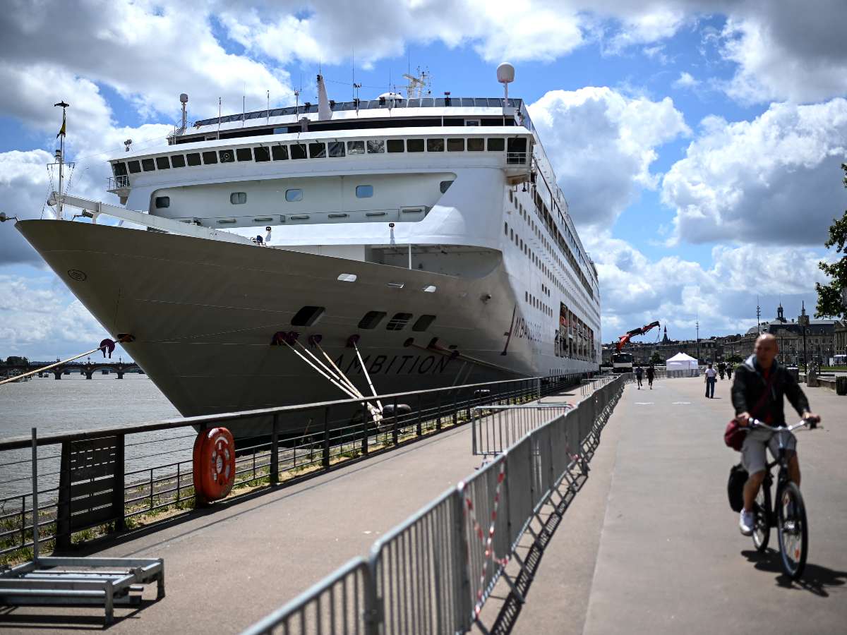 Un hombre pasa junto al crucero Ambition en Burdeos, Francia, tras el confinamiento por un brote gastrointestinal.