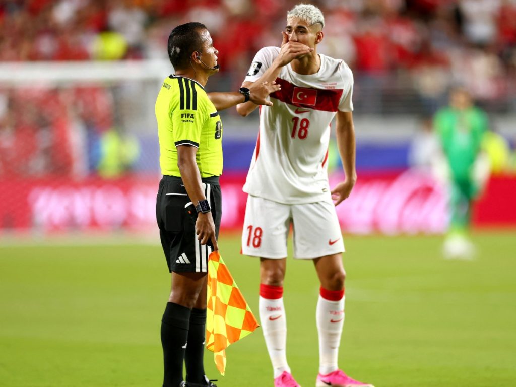 Mert Müldür (#18) de Turquía señala al árbitro que Miguel Almirón (#10) de Paraguay se cubre la boca durante el partido del Mundial 2026. Almirón fue expulsado.