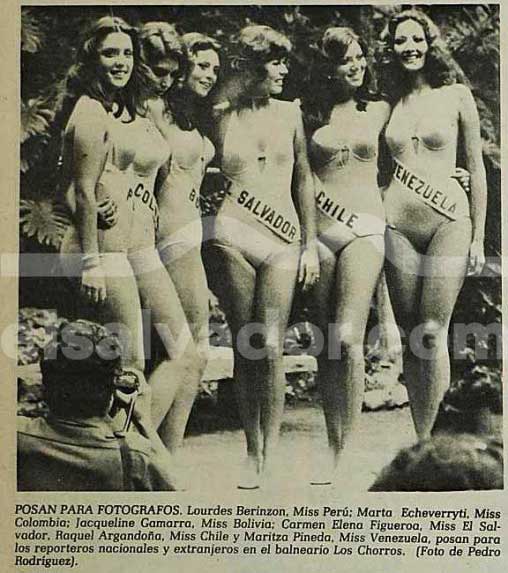 Recorte de periódico antiguo en blanco y negro que muestra a seis candidatas de Miss Universo 1975 posando en trajes de baño enterizos claros con bandas cruzadas que indican sus países: Perú, Colombia, Bolivia, El Salvador, Chile y Venezuela. Al frente, abajo a la izquierda, se ve la espalda de un fotógrafo agachado con su cámara.