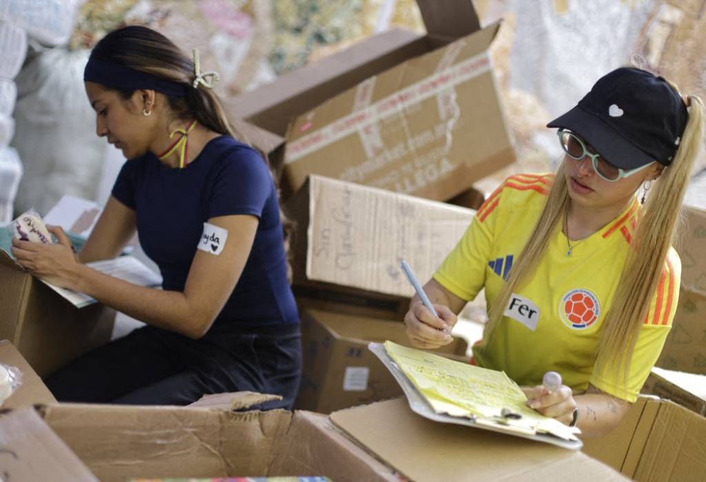 Cajas de cartón selladas y organizadas en el centro de acopio listas para ser transportadas.