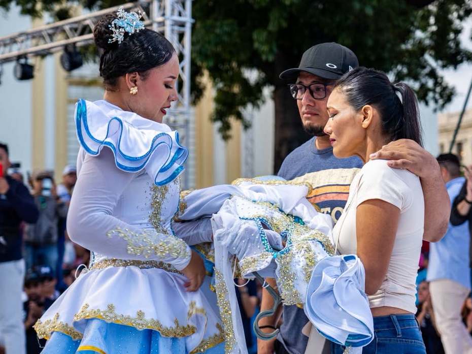 Los padres de Katherine Michelle Rodríguez recibieron el uniforme que su hija utilizó como cachiporrista de la Banda Bicentenario durante el homenaje póstumo. Foto/ Cortesía