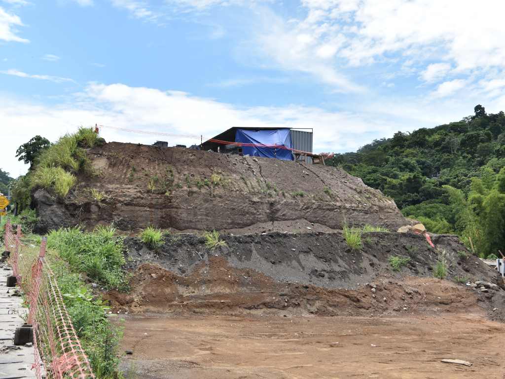 Maquinaria pesada compacta y nivela un gran terraplén de tierra en el área de construcción.