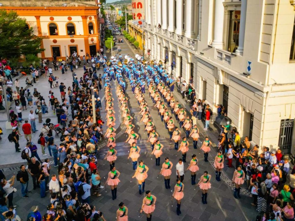 La presentación avanzó desde la plaza Morazán hasta la plaza Gerardo Barrios, acompañada por cachiporristas y personajes tradicionales.