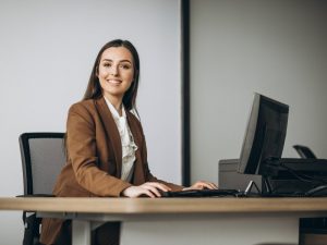 Young business woman working on laptop in office