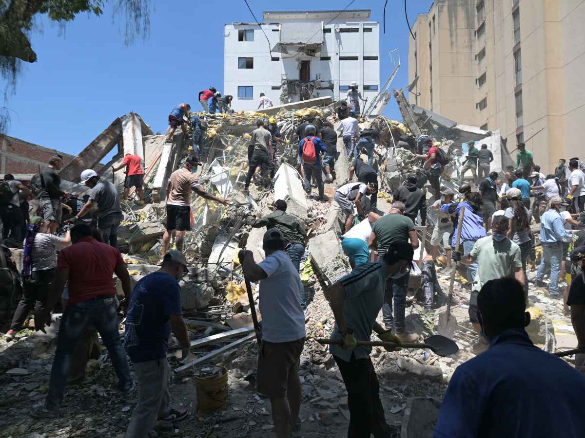 Personas buscan sobrevivientes entre los escombros de un edificio derrumbado tras el terremoto de magnitud 7.4 en Cali, Colombia, el 10 de agosto de 2026.