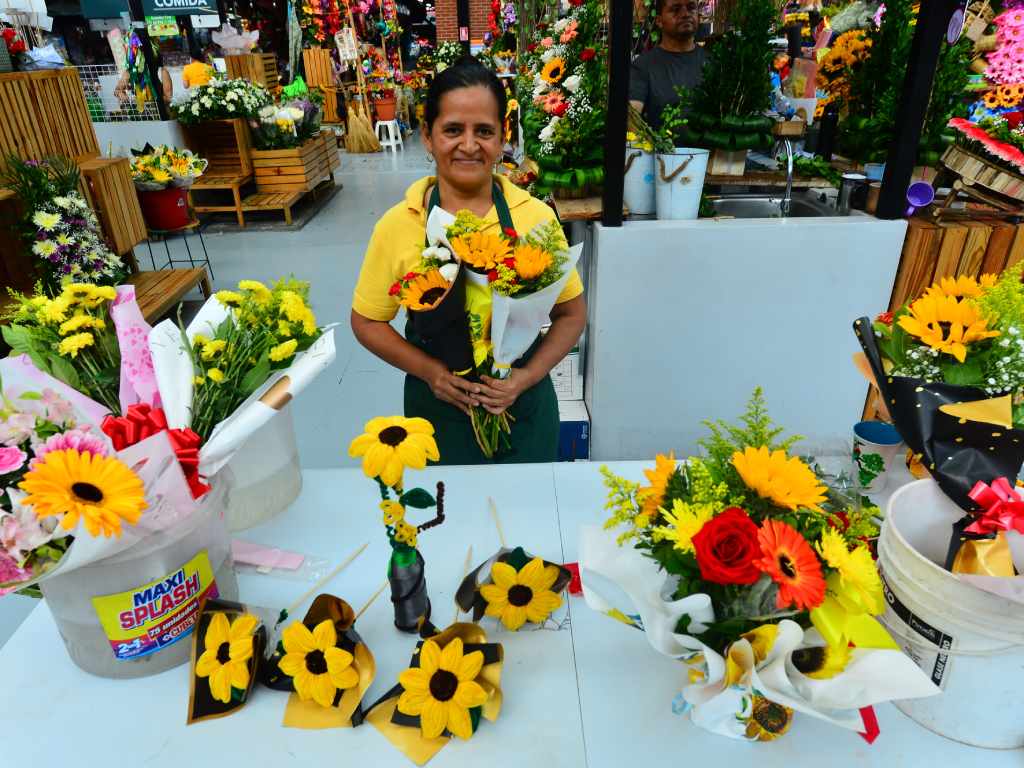 Jackelin de Santos muestra la variedad de arreglos que ofrece floristería Crucita en el mercado San Miguelito.