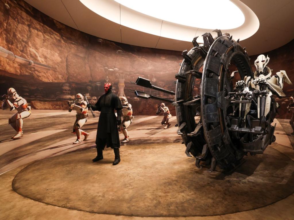 Exhibición con figuras de Darth Maul, el General Grievous en su vehículo rueda y soldados clon en un diorama desértico.