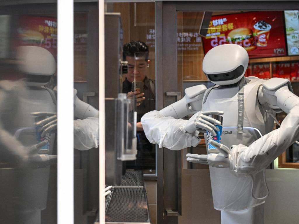 El robot humanoide abriendo el refrigerador, sirviendo la base de helado, agregando toppings y usando la mezcladora.