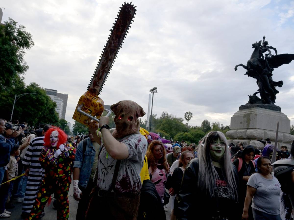 Participantes caracterizados con variados disfraces de brujas, fantasmas, demonios y monstruos clásicos en el recorrido.